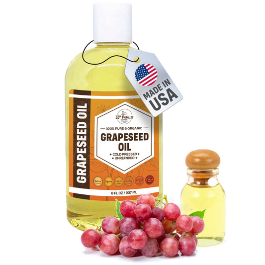 Bottle of grapeseed oil with a tag indicating 'Made in USA', surrounded by grapes on a white background.